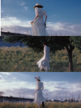 一个穿着白裙子和帽子站在田野中的女人