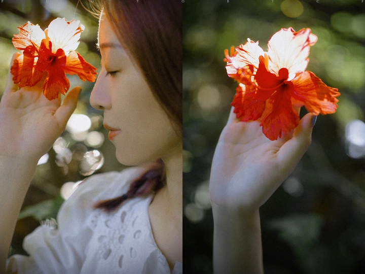 一位穿着白色连衣裙的年轻女子手里拿着一朵红花。