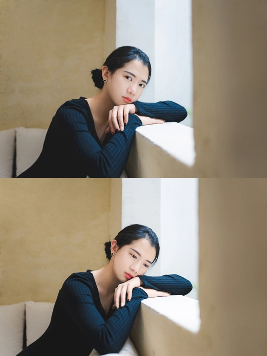 一张年轻女子坐在靠窗的沙发上的照片