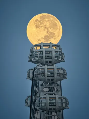 满月从晴朗的蓝天升起