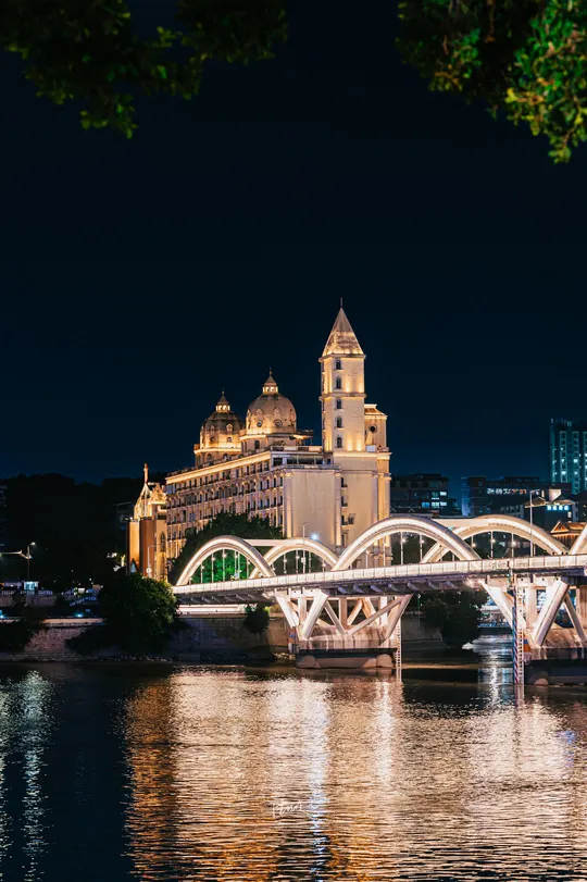 夜晚照亮了城市 一座桥跨过水面。