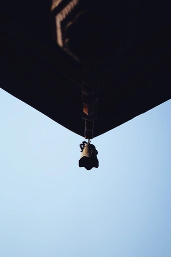 a bell hanging from the side of a building