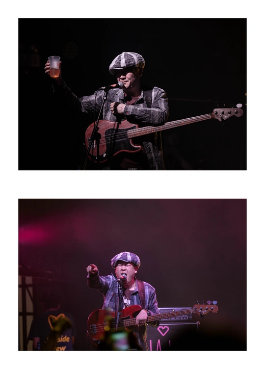 一张一名男子在音乐会舞台上演奏乐器并喝啤酒的照片