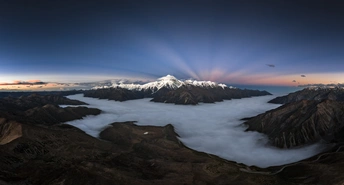 sunrise over the clouds and mountains