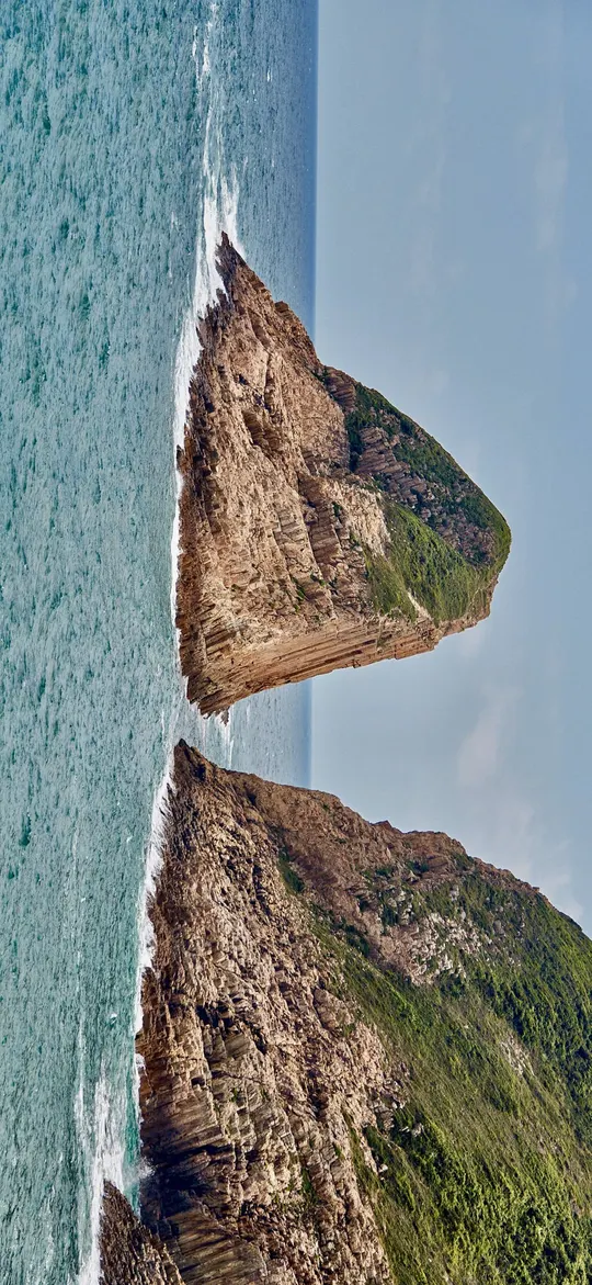 海洋中的一座岛屿的 aerial view 海岸线 瀑布从岩石中流出