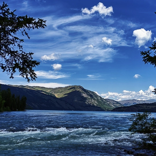 背景是山脉的河流在蓝天下的景象