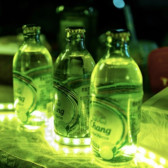 桌子上放着几瓶水 背景是灯光