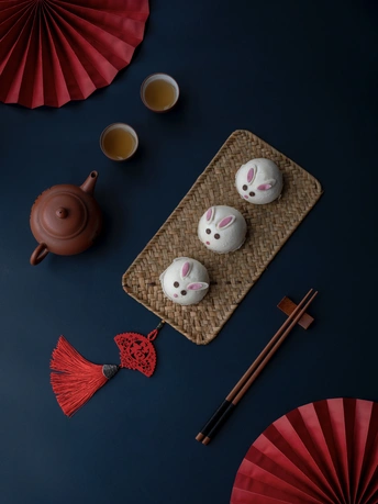 一张桌子 上面放着一些茶杯和一把红色的伞。