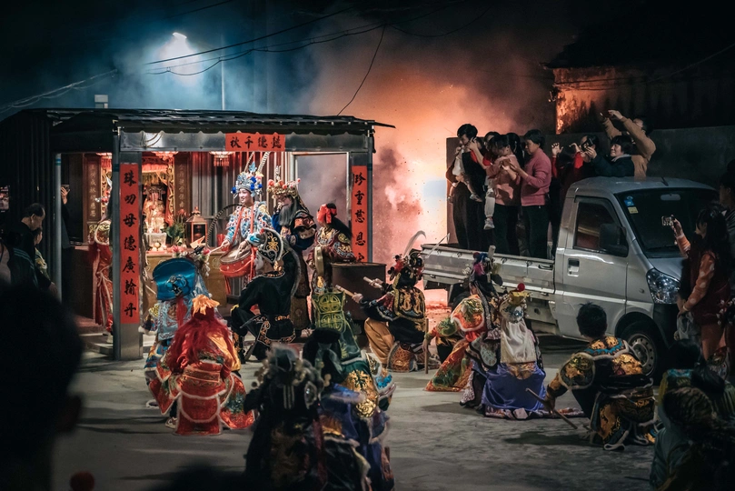 表演者在夜晚的街道上 在卡车前和人群前表演舞蹈。