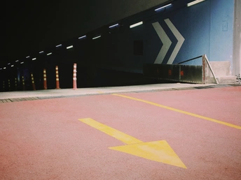 夜晚空荡的停车场 有红色的斜坡 带黄色的箭头。