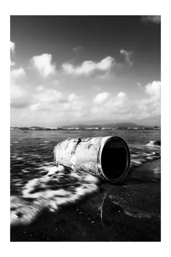 a black and white of a barrel on the shore of the 