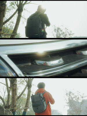 照片的裂缝中 一位男子站在一辆汽车旁 背着一个背包在车盖上。