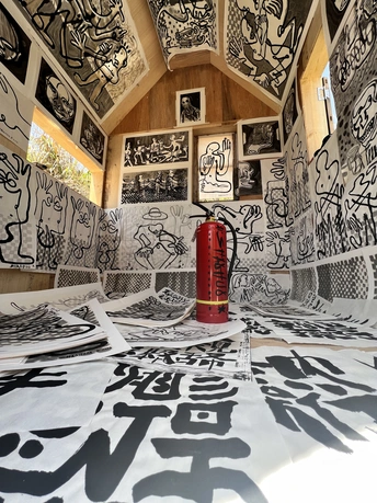 一个被艺术作品覆盖的房间 墙壁和地板上有黑白涂鸦。