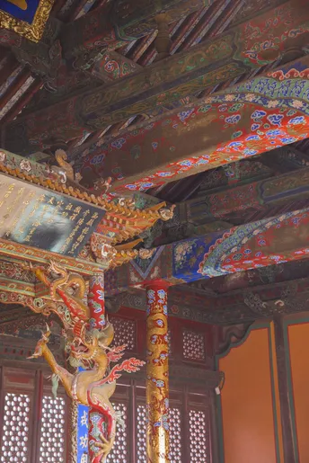 a wooden roof hangs from the ceiling of a building