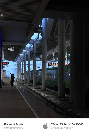 夜晚 一列火车驶入车站 站台上有一个人站着。