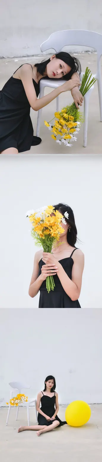 穿黑色连衣裙的女子抱着黄色花