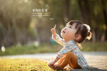 一个小女孩坐在地上 指着天空