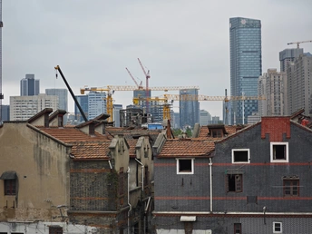 城市中的高楼背景下的老房子