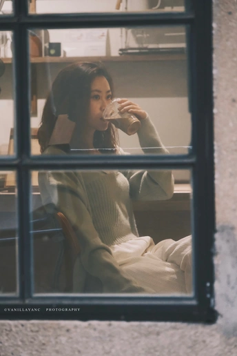 一个坐在窗前喝咖啡的女人