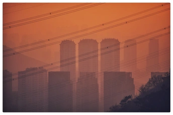 前景中有输电线的模糊的橙色天空的照片