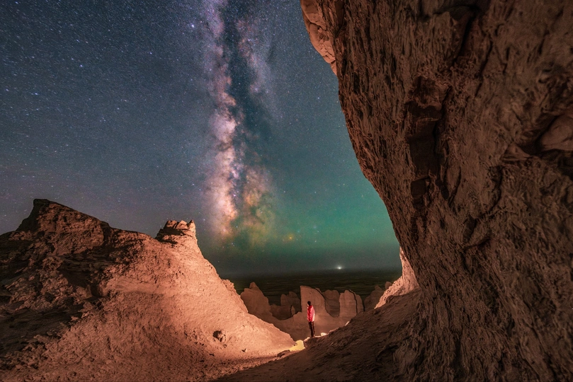 夜晚洞穴中的人 天空中繁星闪烁
