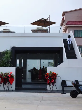 门口有一辆白色摩托车和花