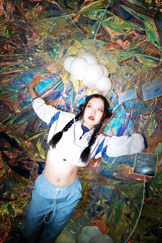 站在一大幅白色气球画前的年轻女子