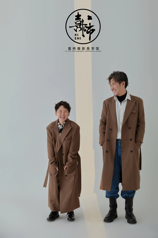 a person standing next to another person in a coat