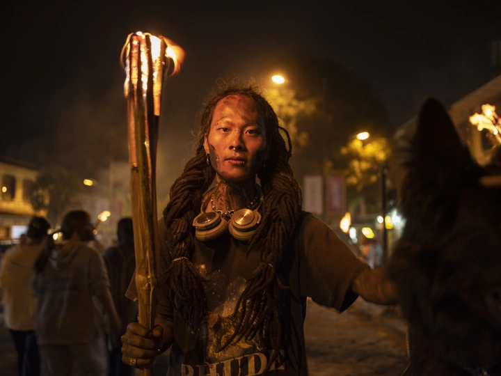 一个人拿着蜡烛和手电筒穿过街道