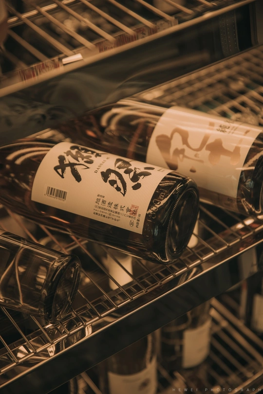 冰箱里装满了瓶装酒 标签上贴着各种酒名。