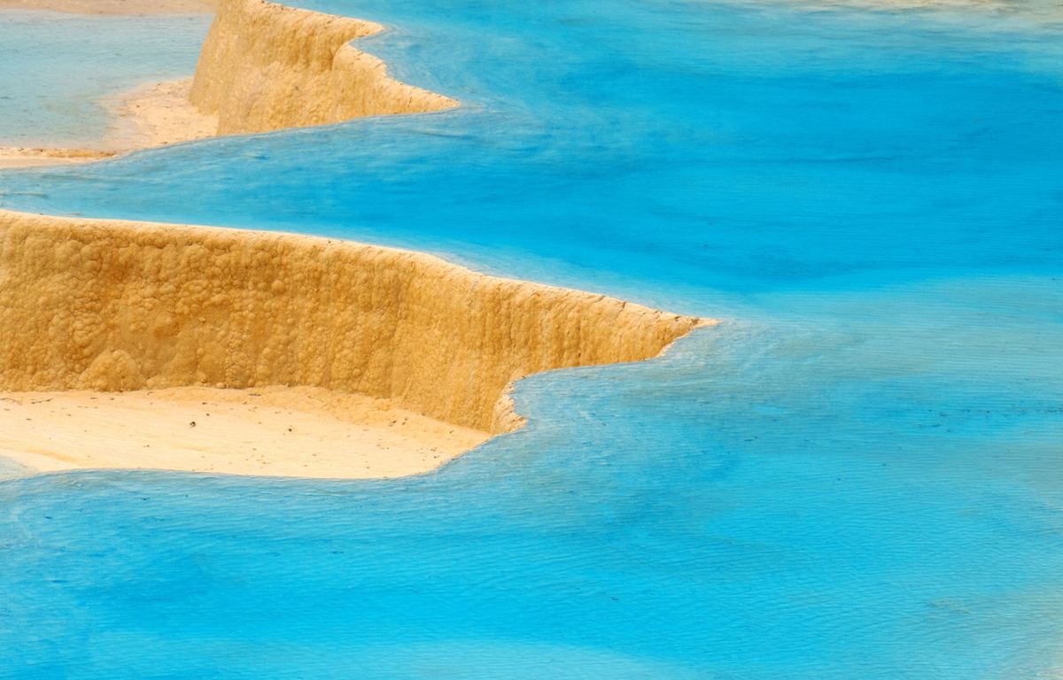 在沙漠景观中央的明亮的蓝色游泳池