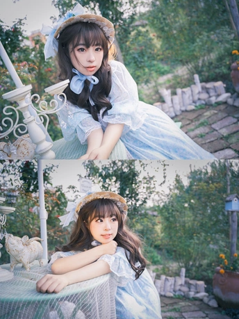 一位穿着白色连衣裙的小女孩坐在花园里