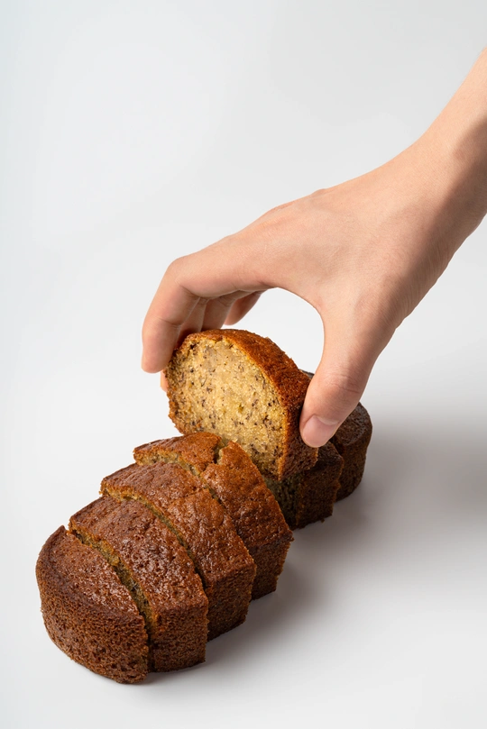 一个人拿着一片面包在白色背景上