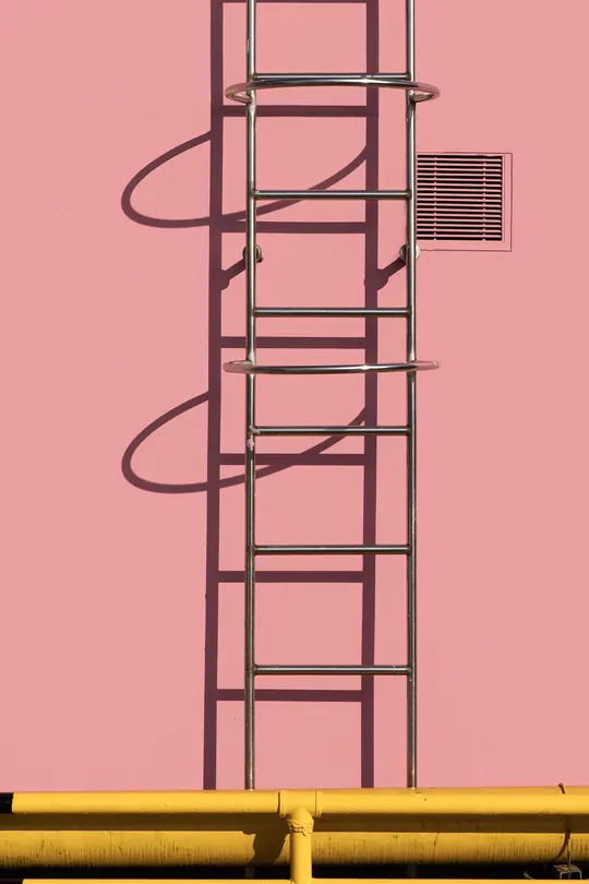 粉红色墙壁上有黄色管道和一座粉色天空中的塔。