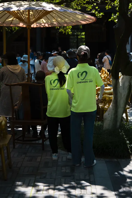 人群在人行道上站在伞下