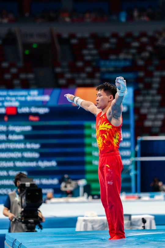 一个站在平衡木上表演的男子