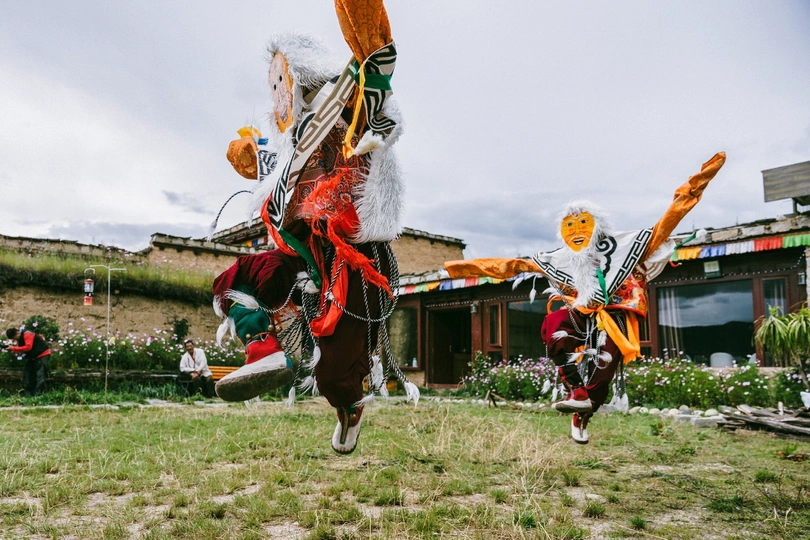 节日中 穿着服装的舞者在草地上表演。