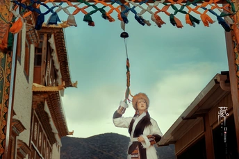 一个男人抱着一个女人在从建筑物上挂着的秋千上。