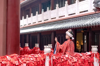 一位穿着红制服的男子站在一栋建筑前