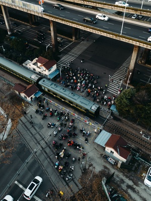 一个人从空中视角拍摄的十字路口 火车穿越道路 人群穿越街道。