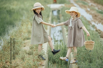 小男孩和小女孩手牵着手在田野里散步