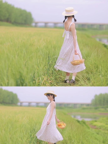 一位穿着白色连衣裙的年轻女子抱着篮子穿过田野