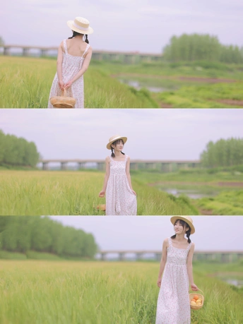 一位穿着白色连衣裙和帽子站在田野里的年轻女子