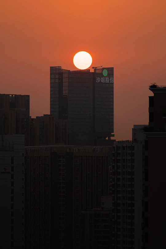 夕阳西下 城市中的高楼大厦背后是落日。