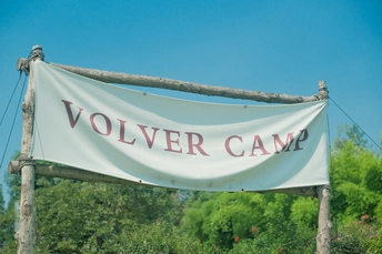 a white sign hanging from the side of a pole