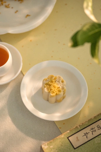 一杯茶 sits on a white saucer next to a small plate w