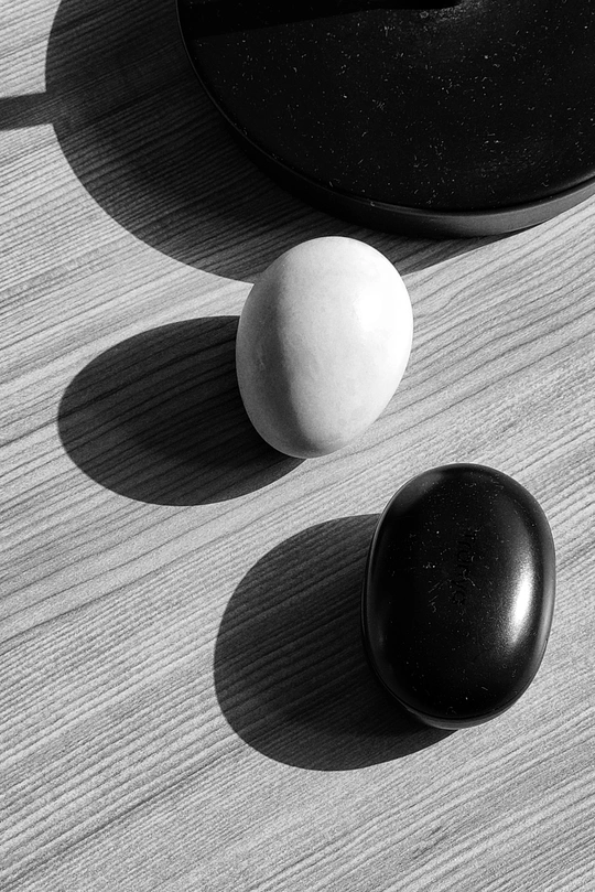 阳光下 一个鸡蛋和一个球坐在木桌上