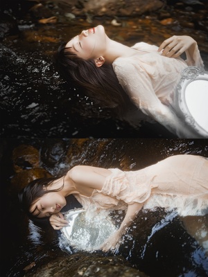 一位穿着白色裙子的美女在一条河或溪流中漂浮
