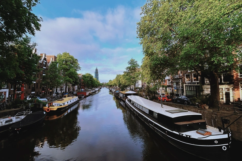 城市中的运河 有树木、建筑和船只。