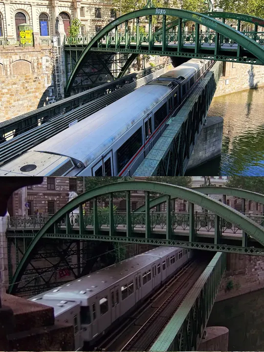 河上的一座绿色桥 桥上有一列火车在轨道上。